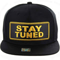 STAY TUNED GOLD PATCH DETAILING PU SNAPBACK CAP